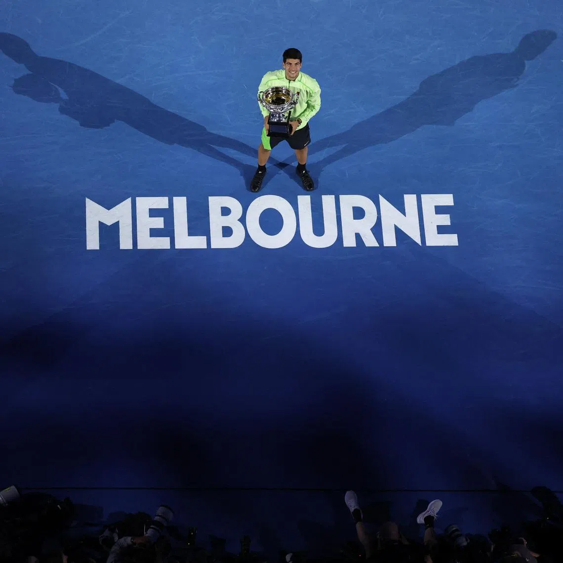Tennis - Australian Open - Melbourne Park, Melbourne, Australia - February 1, 2026 Spain's Carlos Alcaraz celebrates with the trophy after winning the Australian Open men's singles against Serbia's Novak Djokovic. Alcaraz becomes the youngest man to win all four grand slam titles. REUTERS/Hollie Adams