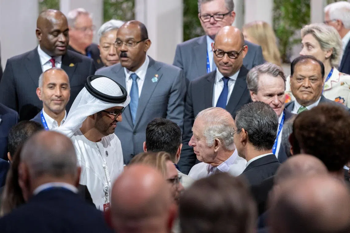 Britain's King Charles speaking to COP28 president Sultan Al Jaber, as they attend the launch of the climate summit in the UAE.