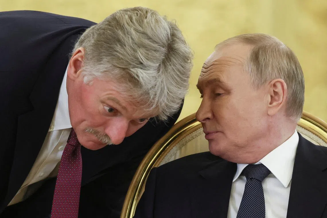 FILE PHOTO: Russian President Vladimir Putin speaks with Kremlin spokesman Dmitry Peskov during a summit of leaders of nations, which are members of the Commonwealth of Independent States (CIS), in Moscow, Russia October 8, 2024. Sergei Ilnitsky/Pool via REUTERS/File Photo