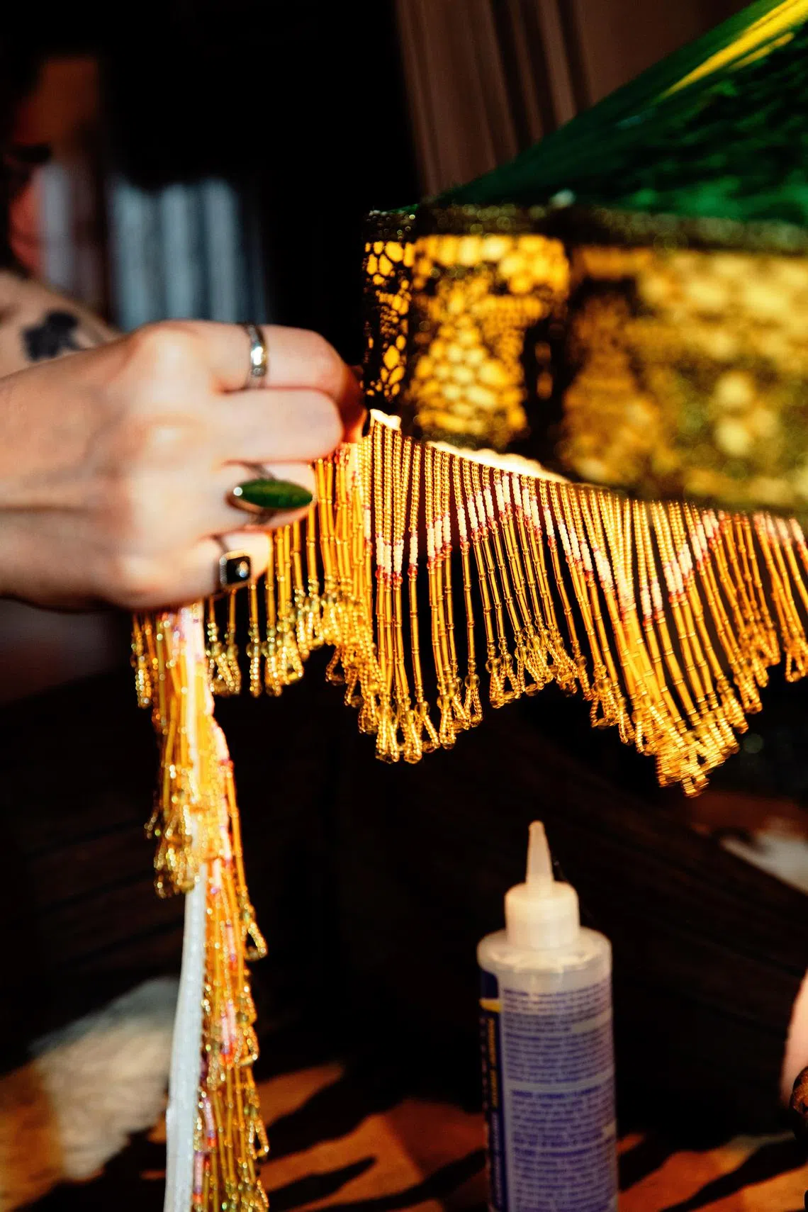 Ivy Karlsgodt glues beaded trim to a Victorian-style lampshade in her home studio in New York, May 6, 2024. Viewers of her videos online find KarlsgodtÕs creations beautiful and her process meditative. (Justin J Wee for/The New York Times)