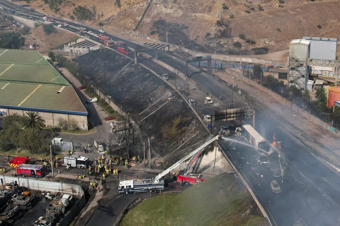A drone view shows firefighters working at the site of a deadly explosion, according to local media, in Santiago, Chile, February 19, 2026. REUTERS/Pablo Sanhueza        TPX IMAGES OF THE DAY