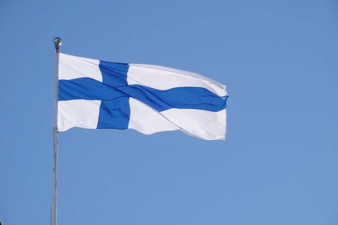FILE PHOTO: The Finnish flag flutters outside the city hall, as Finland becomes a member of NATO, in Helsinki, Finland, April 4, 2023. REUTERS/Tom Little/File Photo