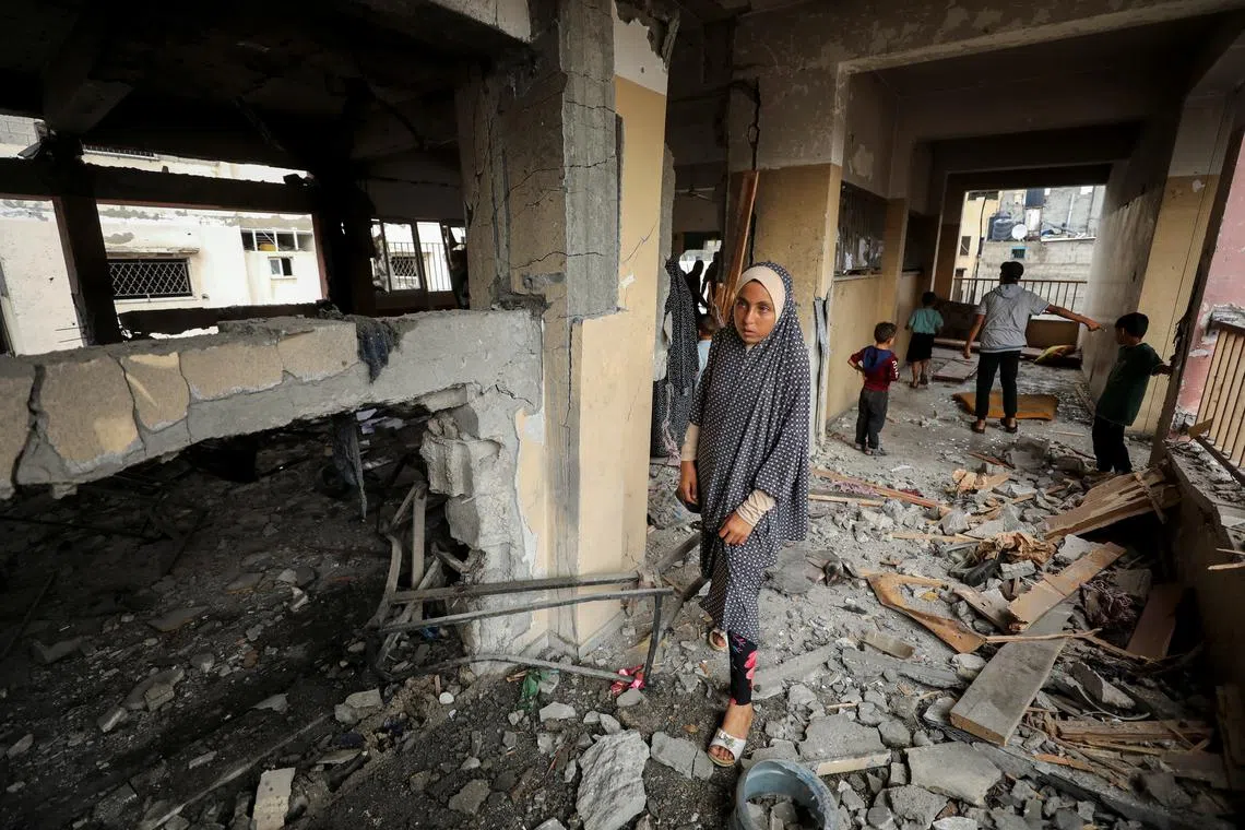 Palestinians inspect the damage to a school sheltering displaced people after it was hit by an Israeli strike, amid the Israel-Hamas conflict, at Beach refugee camp in Gaza City, September 22, 2024. REUTERS/Dawoud Abu Alkas