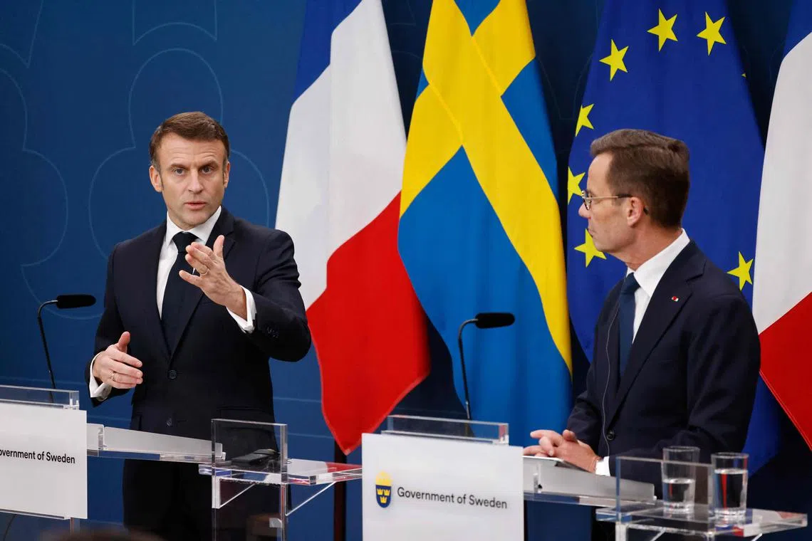 Swedish Prime Minister Ulf Kristersson (right) listens as French President Emmanuel Macron addresses at joint press conference, in Stockholm, Sweden.