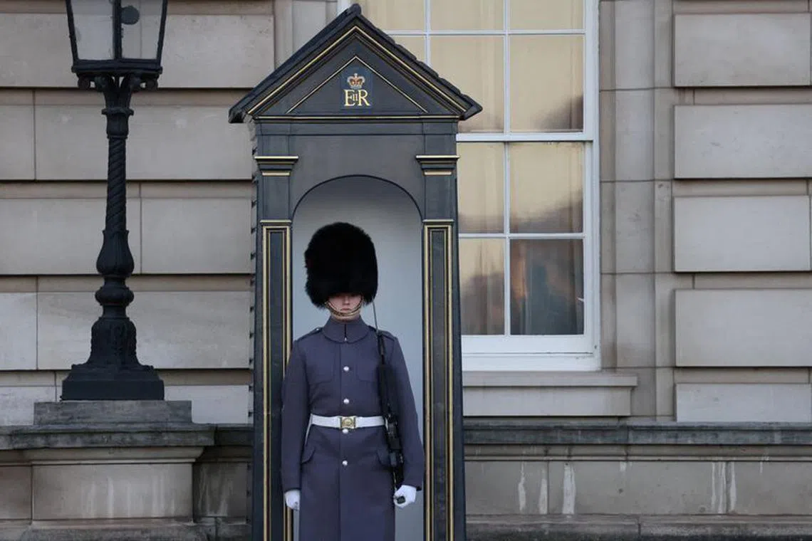 A guard wearing a bearskin cap stands outside Buckingham Palace in London, Britain January 10, 2024. REUTERS/Hollie Adams