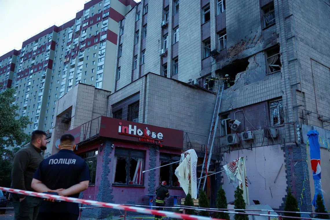 Rescuers working at the site of a building damaged during a Russian suicide drone strike in Kyiv, Ukraine, on May 28, 2023. 