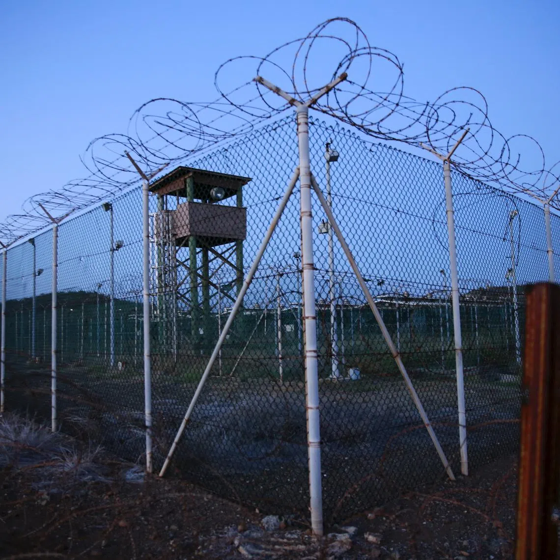 FILE PHOTO: Chain link fence and concertina wire surrounds a deserted guard tower within Joint Task Force Guantanamo's Camp Delta at the U.S. Naval Base in Guantanamo Bay, Cuba March 21, 2016.  REUTERS/Lucas Jackson/File Photo