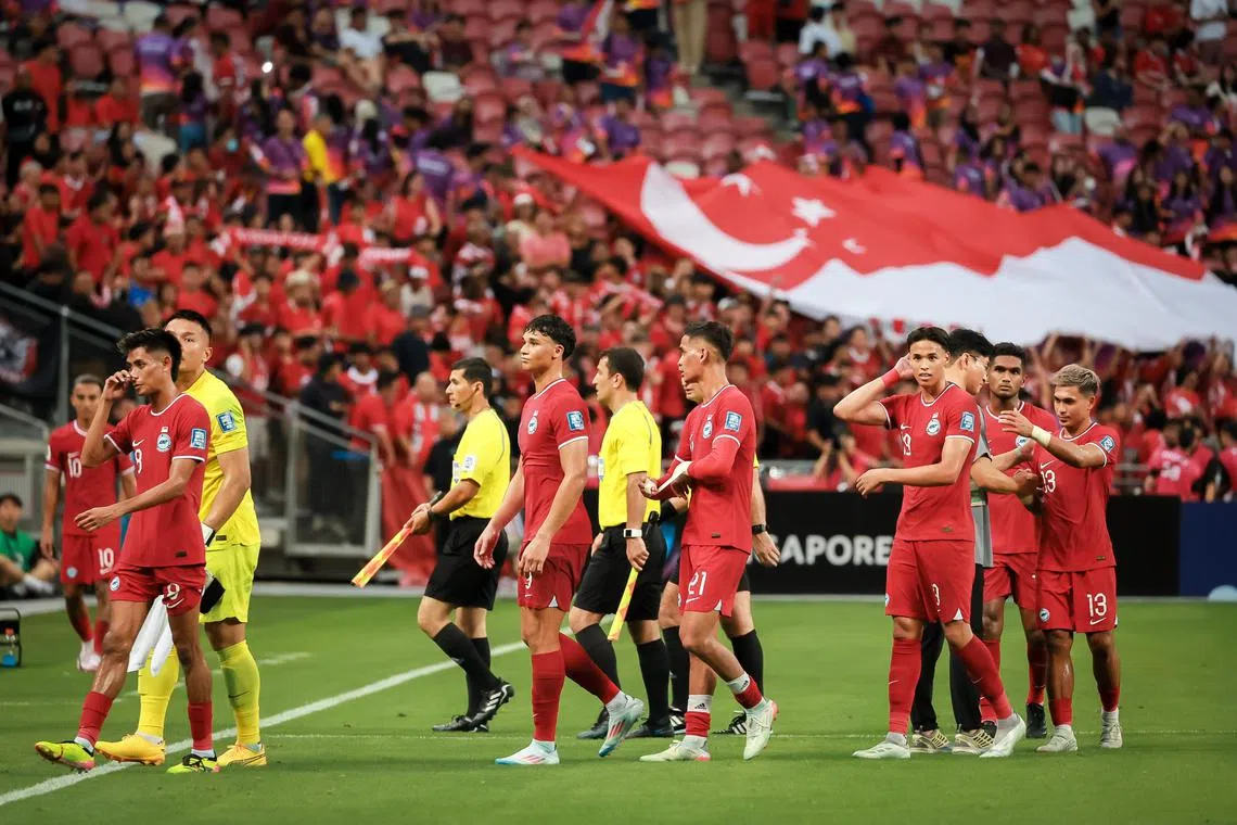 The Singapore national football team trooping off the pitch after losing 7-0 to South Korea in a World Cup qualifier at the National Stadium on June 6. 