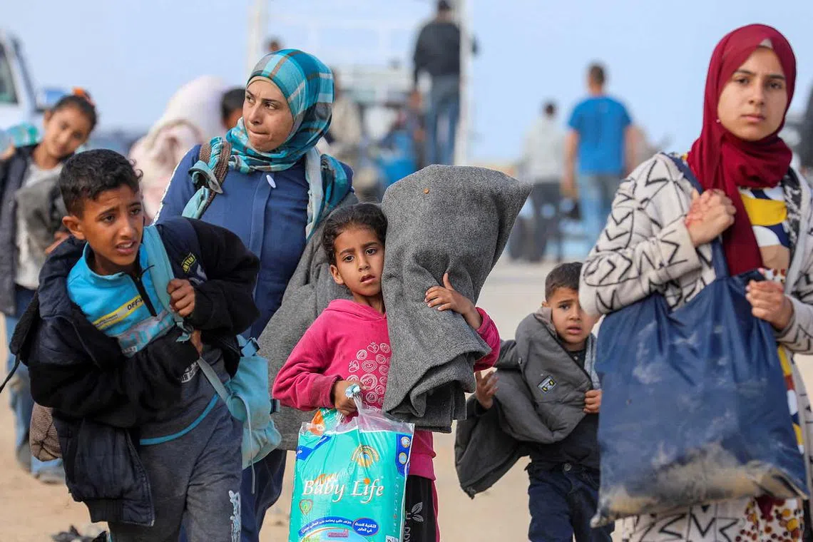 Palestinians, who were displaced by Israel's military offensive on south Gaza, attempting to return to their homes in north Gaza through an Israeli checkpoint in central Gaza Strip on April 15, 2024. 