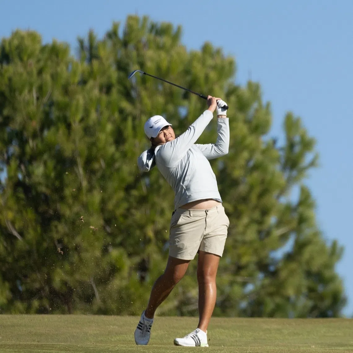 Singaporean golfer Shannon Tan is seven strokes behind leader Leah John from Canada.