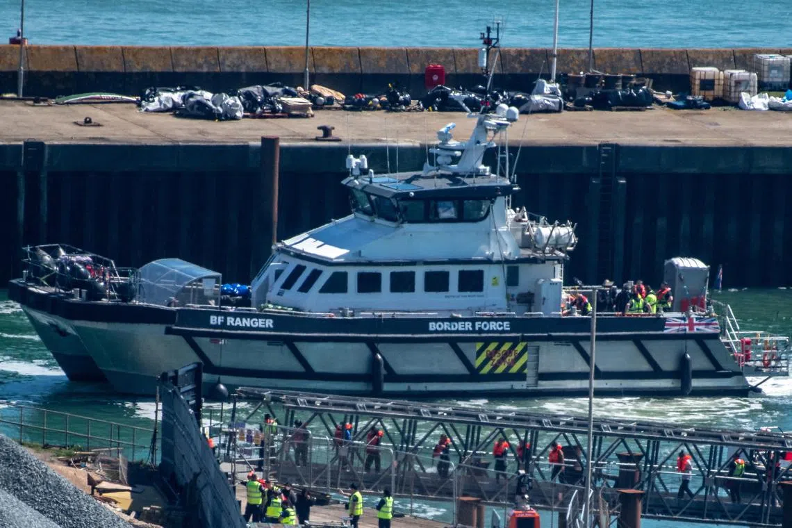 FILE PHOTO: People believed to be migrants, disembark from a British Border Force vessel as they arrive at the Port of Dover in Dover, Britain, April, 29, 2024. REUTERS/Chris J. Ratcliffe/File Photo