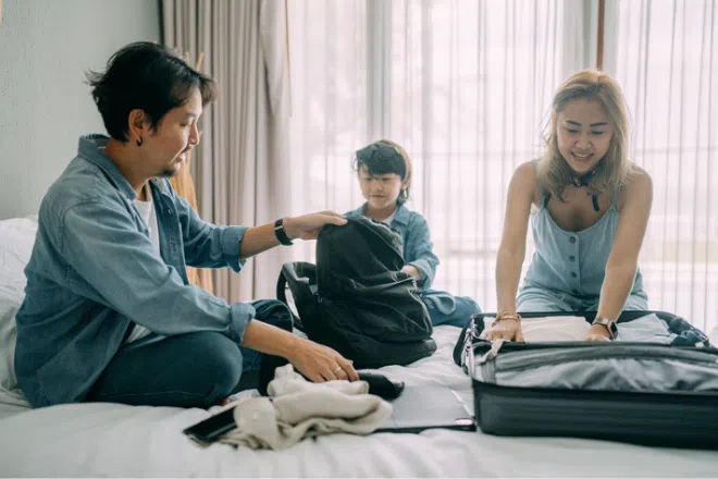 Family packing luggage to go on holiday