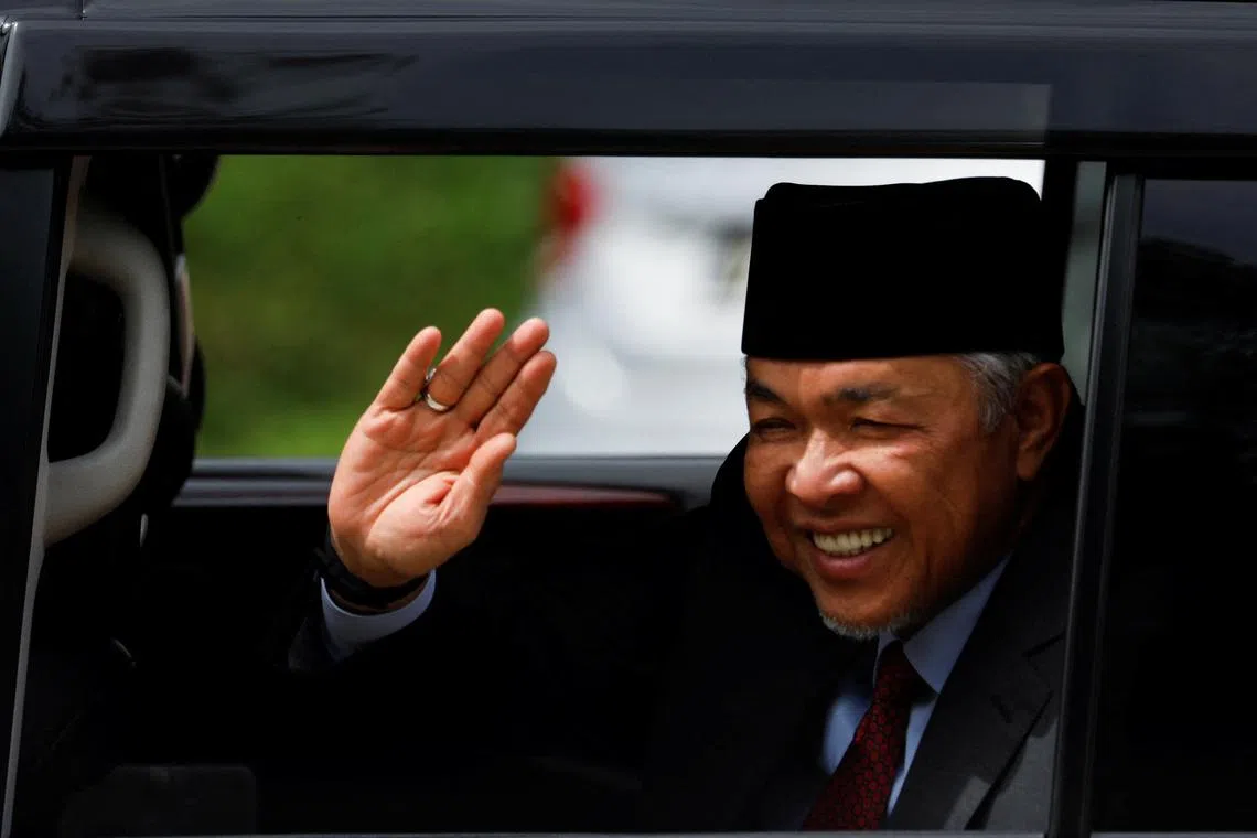 Barisan Nasional chief Ahmad Zahid Hamidi waves as he leaves the National Palace in Kuala Lumpur, on Nov 23, 2022.
