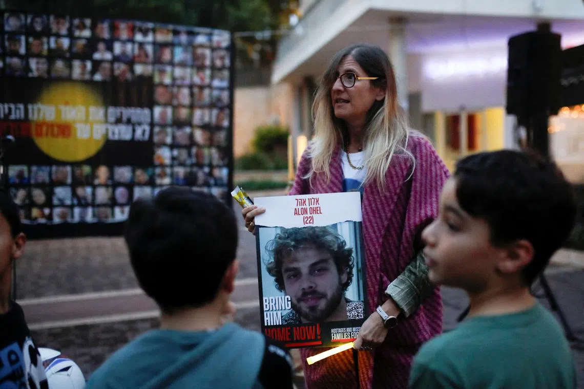 FILE PHOTO: Family of Alon Ohel, 22, who was taken hostage by Palestinian Islamist group Hamas during the deadly October 7 attack, gathers with other families of hostages to light candles to mark the first night of the Jewish holiday of Hanukkah, in Karmiel, in northern Israel  December 7, 2023. REUTERS/Shir Torem/File Photo