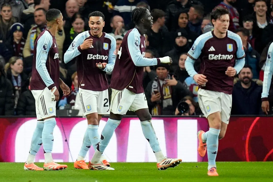 epa12607613 Morgan Rogers of Aston Villa (2nd left) celebrates his goal during the English Premier League match between Aston Villa and Manchester United, in Birmingham, Britain, 21 December 2025.  EPA/TIM KEETON
