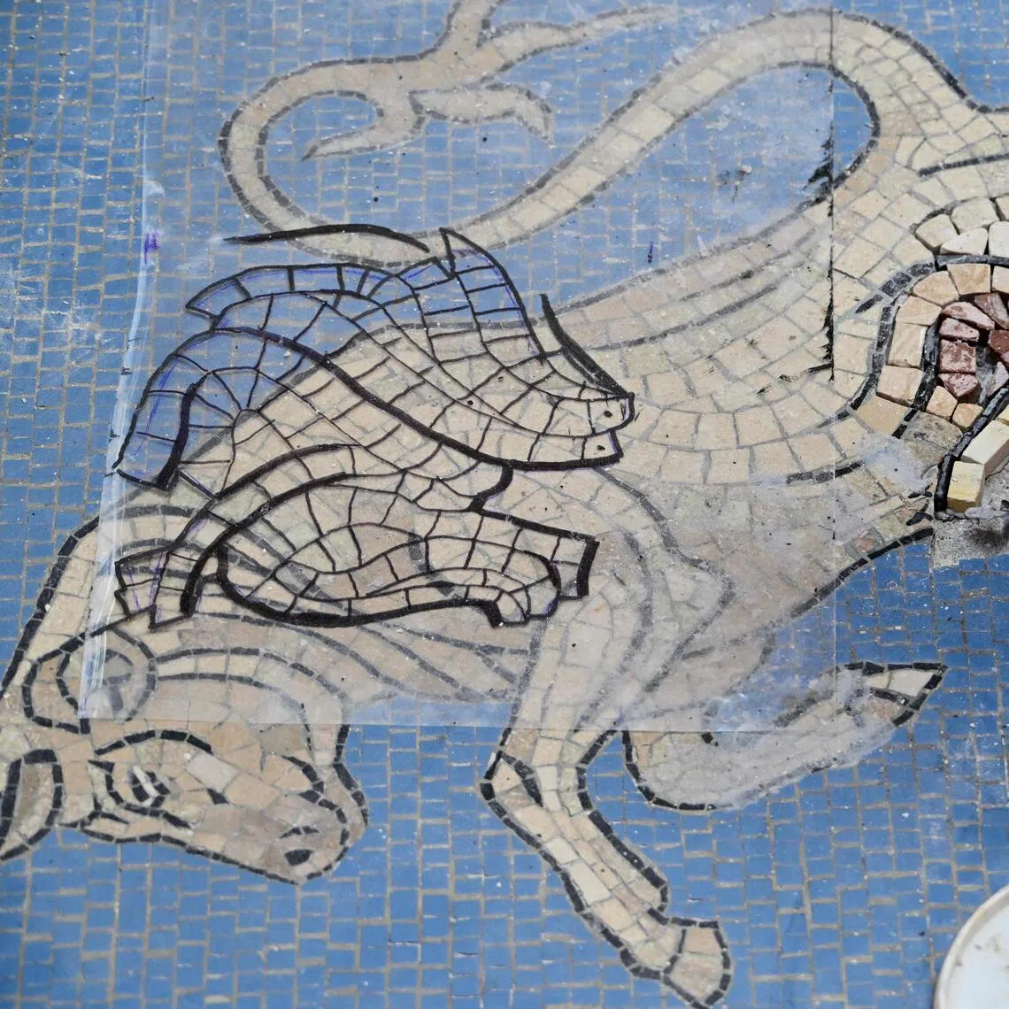 Restorer Gianluca Galli works on the bull mosaic at the Galleria Vittorio Emanuele II, in Milan.