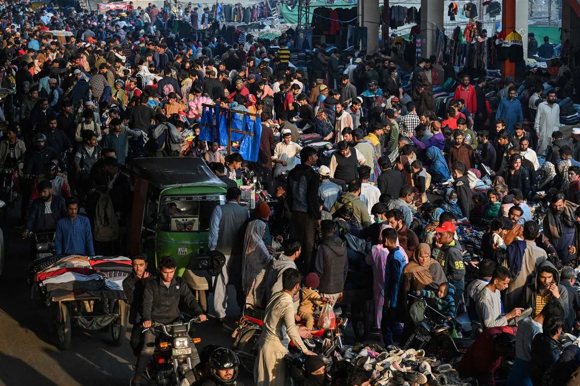 Shoppers crowd at a market to buy warm clothes for winter in Lahore on Dec 4, 2022.