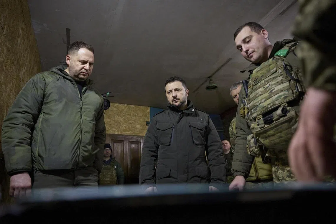 Mr Zelensky (centre) with servicemen during his visit to the battalion command post of the 14th separate mechanised brigade near a frontline in the Kupiansk area, Ukraine.