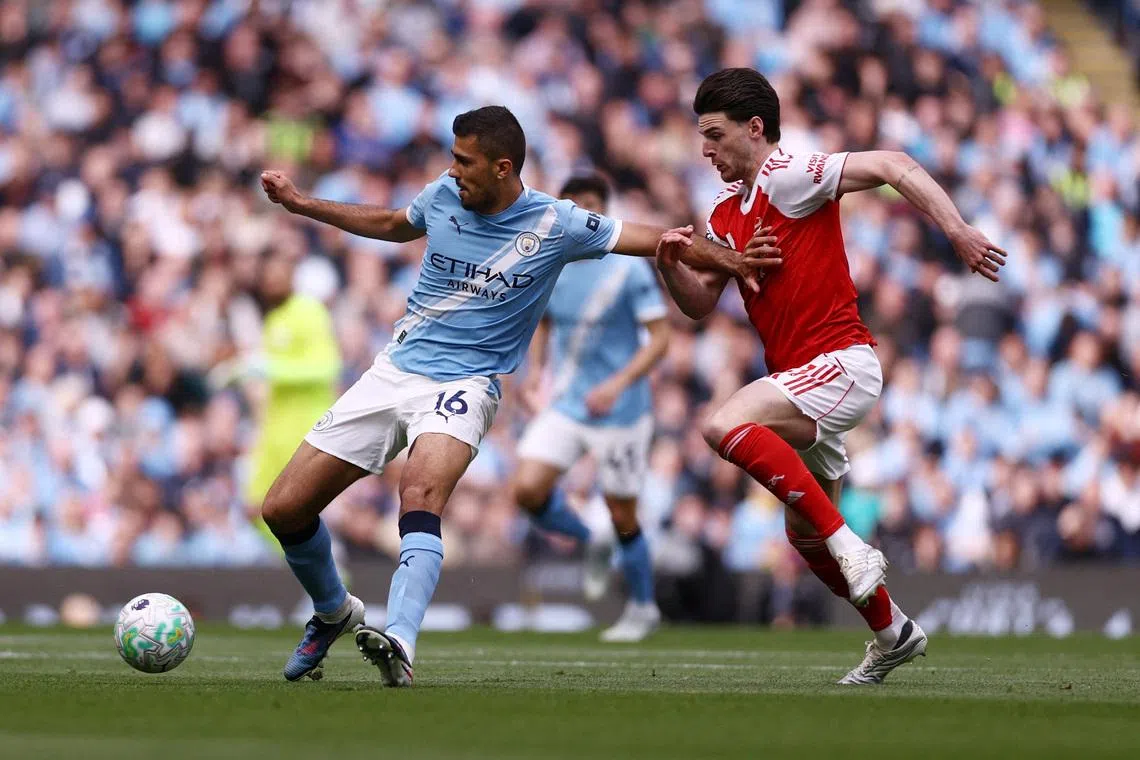 FILE PHOTO: Soccer Football - Premier League - Manchester City v Arsenal - Etihad Stadium, Manchester, Britain - April 19, 2026 Manchester City's Rodri in action with Arsenal's Declan Rice Action Images via Reuters/Lee Smith/File Photo