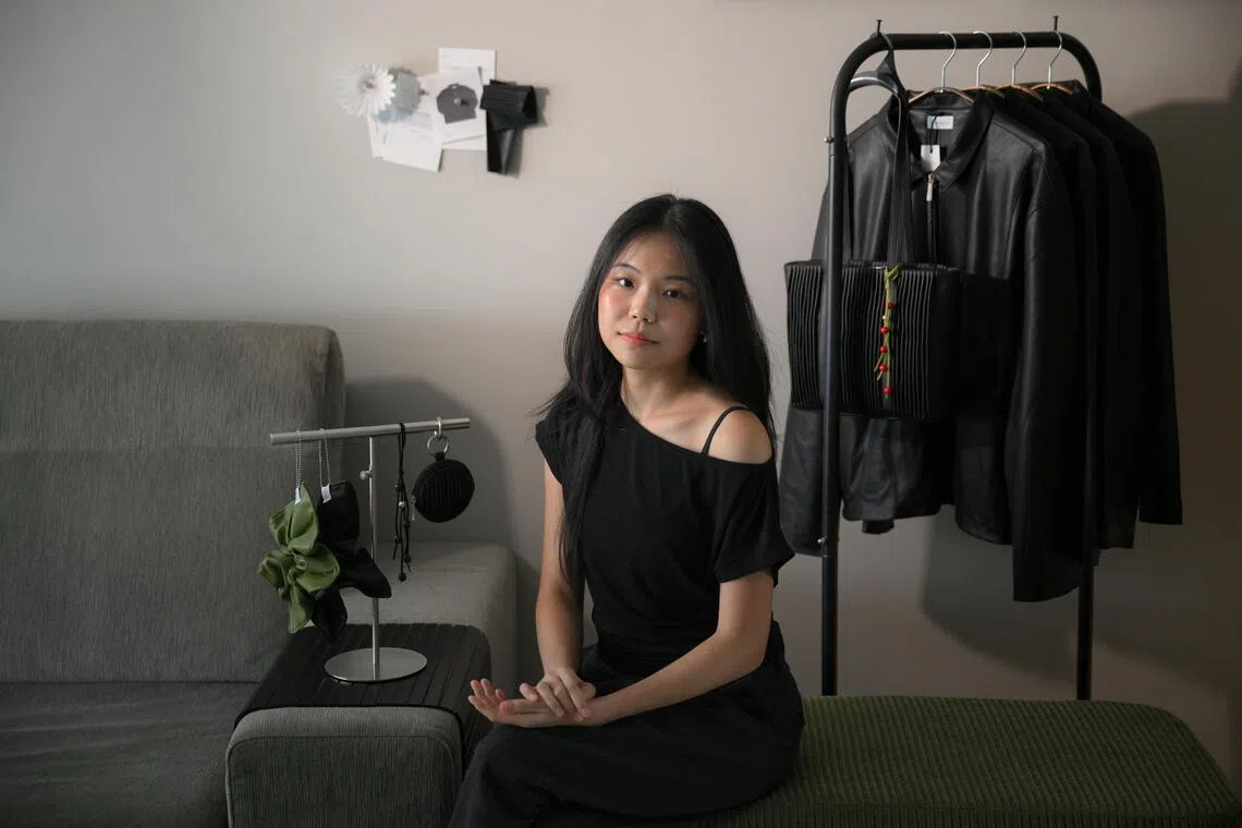 Apple Lau, the founder of Aomorie, with her coffee leather jackets and pleated Bloom bag.
