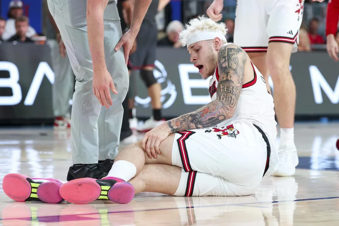 Nov 29, 2024; Paradise Island, Bahamas, BHS;  Louisville Cardinals forward Kasean Pryor (7) injures his leg against the Oklahoma Sooners during the second half at Imperial Arena at the Atlantis resort.  Mandatory Credit: Kevin Jairaj-Imagn Images/ File Photo