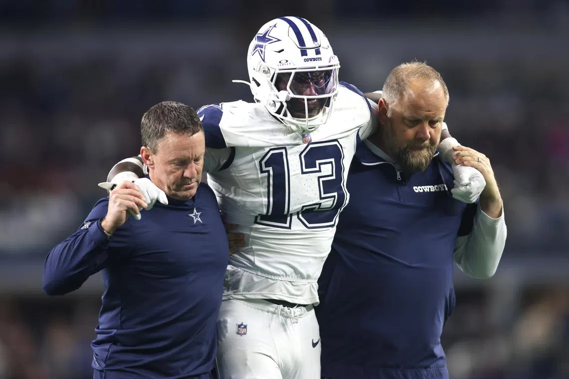 Dec 9, 2024; Arlington, Texas, USA; Dallas Cowboys linebacker DeMarvion Overshown (13) is helped off the field after an injury in the second half against the Cincinnati Bengals at AT&T Stadium. Tim Heitman-Imagn Images/File Photo
