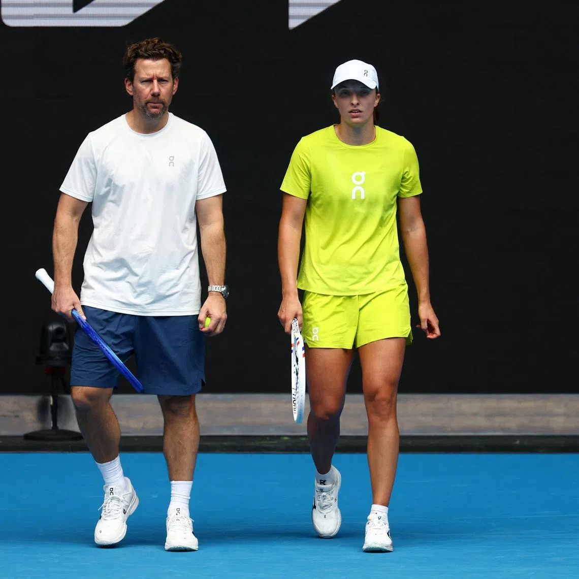 Tennis - Australian Open - Practice - Melbourne Park, Melbourne, Australia - January 9, 2025 Poland's Iga Swiatek with coach Wim Fissette during a practice session ahead of the Australian Open REUTERS/Edgar Su