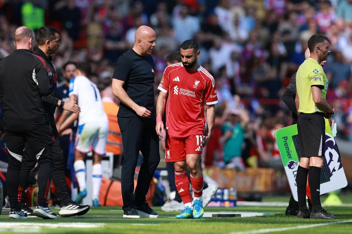 Soccer Football - Premier League - Liverpool v Crystal Palace - Anfield, Liverpool, Britain - April 25, 2026 Liverpool's Mohamed Salah with manager Arne Slot after being substituted REUTERS/Phil Noble