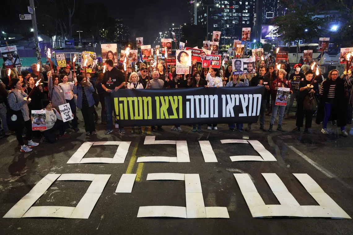 Demonstrators calling for action to secure the release of Israelis held hostage in Gaza in front of the Israeli defence ministry in Tel Aviv, on Jan 15.