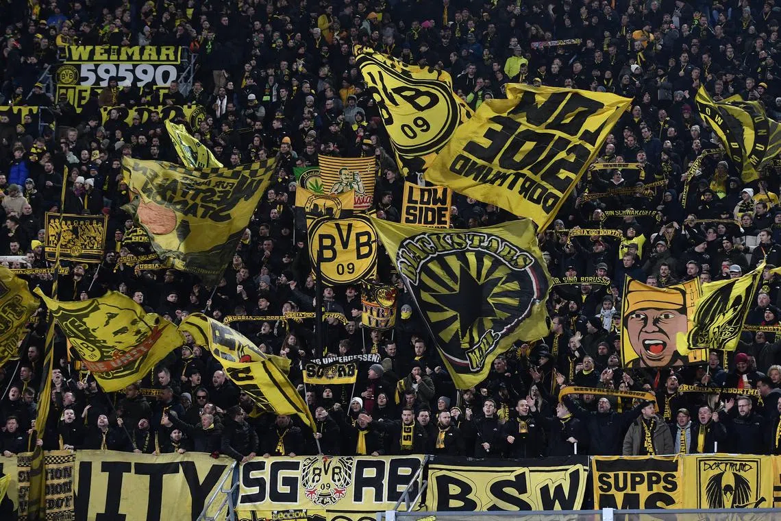 FILE PHOTO: Soccer Football - Champions League - Bologna v Borussia Dortmund - Stadio Renato Dall'Ara, Bologna, Italy - January 21, 2025 Borussia Dortmund fans with flags inside the stadium before the match REUTERS/Jennifer Lorenzini/File Photo