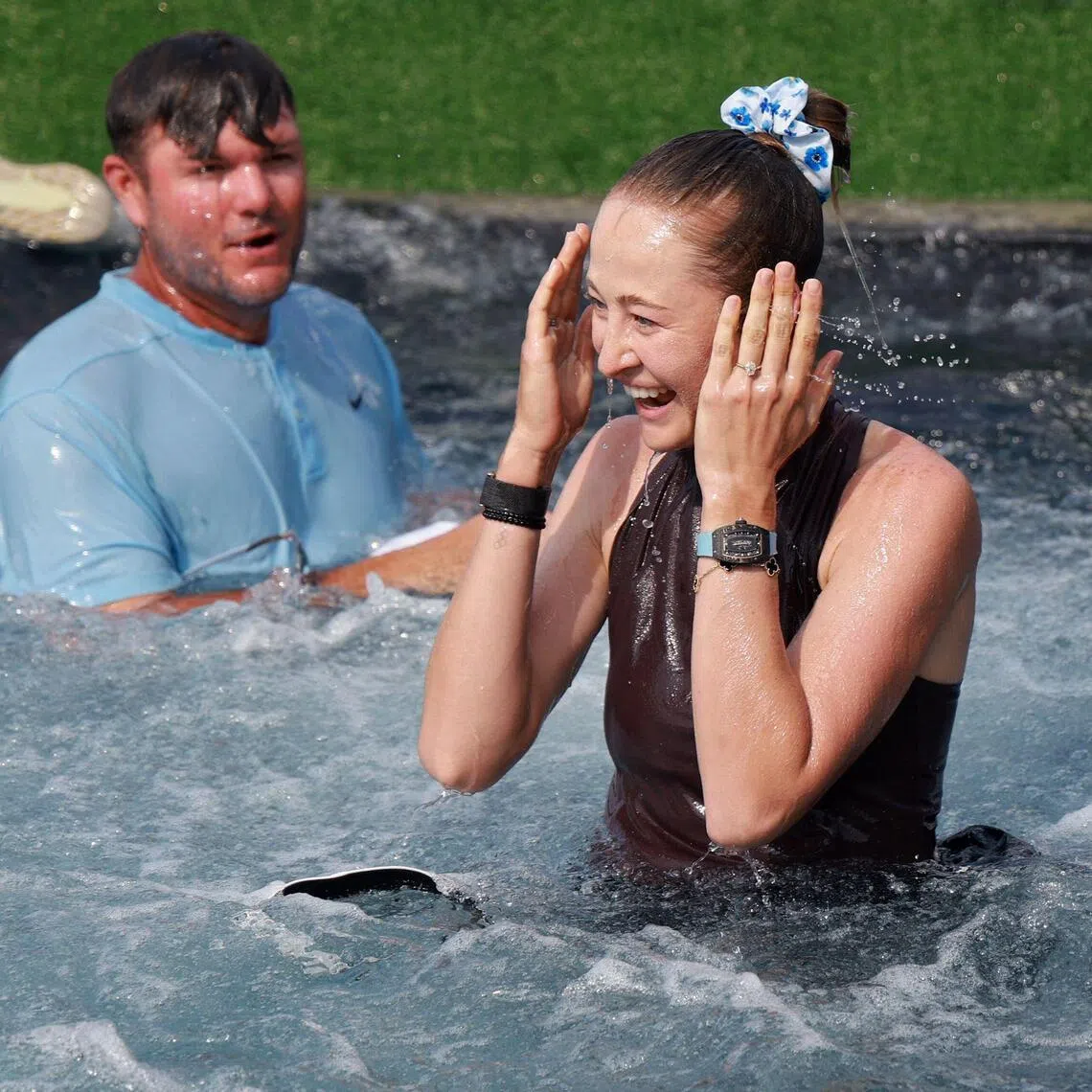 Nelly Korda of the United States and caddie Jason McDede react after jumping into Poppie's Pond after winning the 2026 Chevron Championship at Memorial Park Golf Course on April 26, 2026 in Houston, Texas.