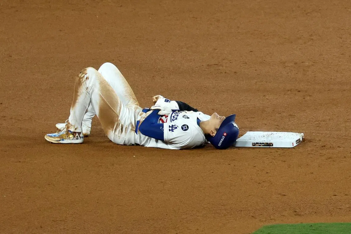 Oct 26, 2024; Los Angeles, California, USA; Los Angeles Dodgers designated hitter Shohei Ohtani (17) reacts after injuring his shoulder against the New York Yankees in the seventh inning for game two of the 2024 MLB World Series at Dodger Stadium. Mandatory Credit: Kiyoshi Mio-Imagn Images
