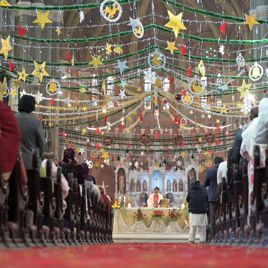 Members of the Christian minority community attend a Christmas Holy Mass at Sacred Heart Cathedral Church in Lahore, Pakistan on Dec 25, 2025. Around the world, people celebrate Christmas to commemorate the birth of Jesus Christ. 