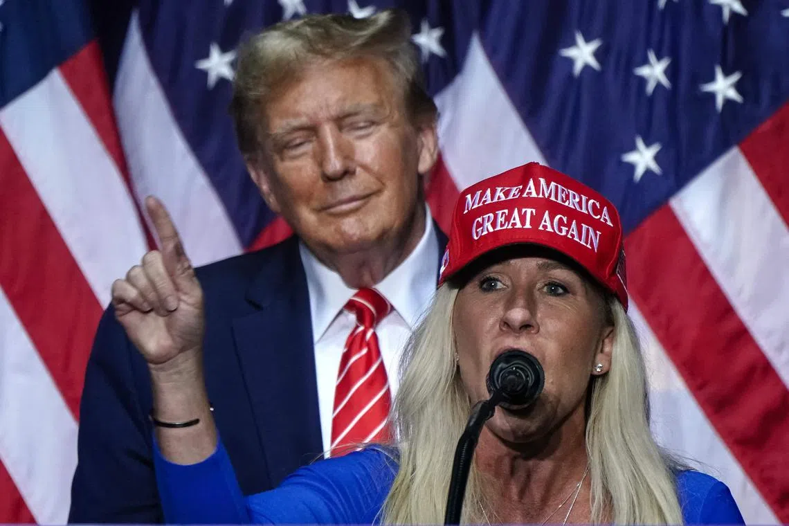 US Representative Marjorie Taylor Greene with Donald Trump at a campaign event in Rome, Georgia, on March 9. Known by her initials MTG, she is a Trump loyalist who believes the 2020 election was “stolen” from him.
