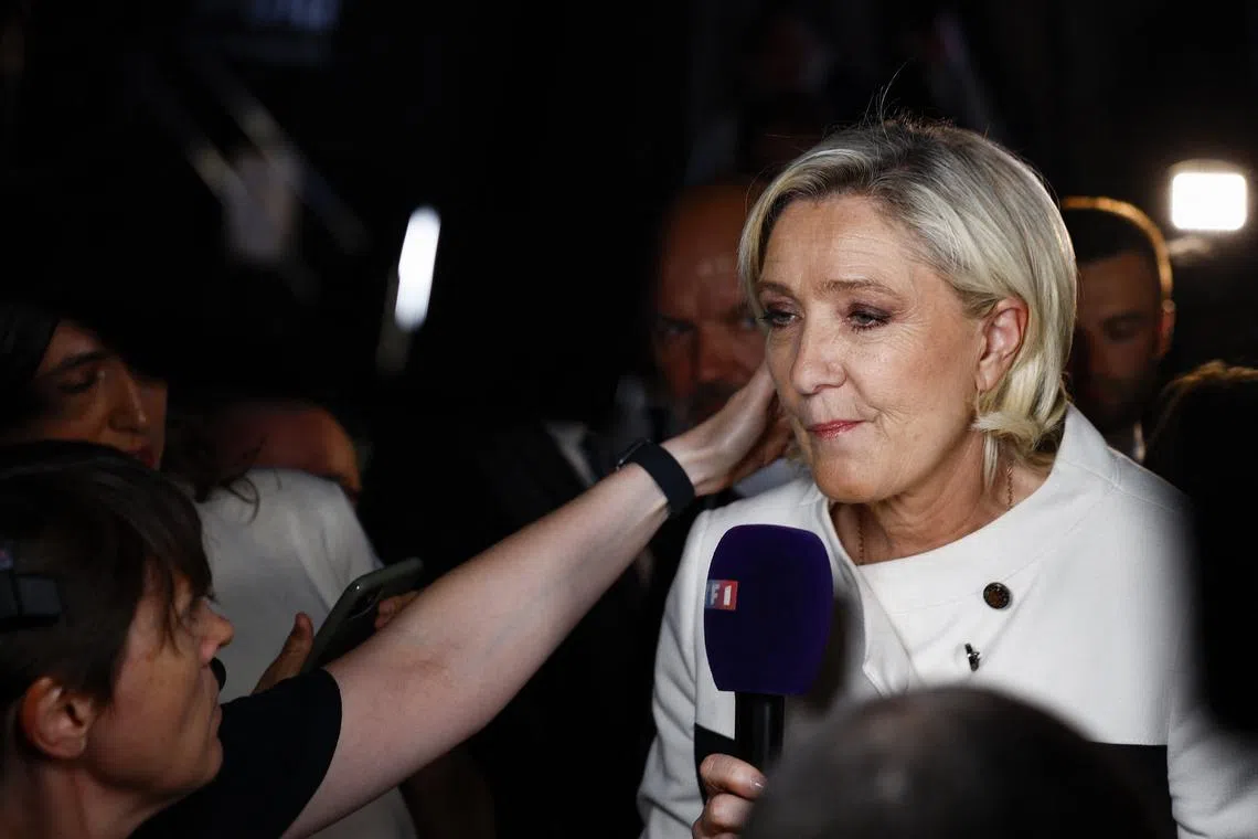 French far-right leader Marine Le Pen talks to journalists after partial results in the second round of the early French parliamentary elections, at the French far-right Rassemblement National (National Rally - RN) party venue in Paris, France, July 7, 2024. REUTERS/Sarah Meyssonnier