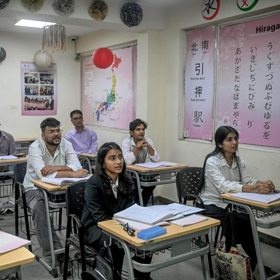 Students hoping to work in Japan study Japanese at a language school in New Delhi.