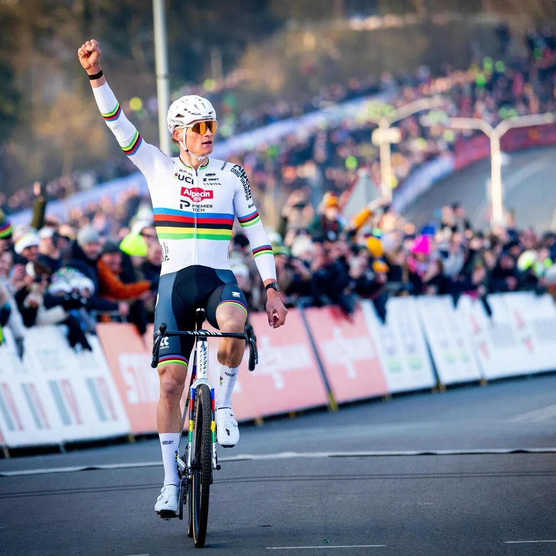 Mathieu van der Poel of the Netherlands celebrates his victory in the men elite race of the UCI Cyclo-cross World Cup in Hoogerheide, Netherlands, on Jan 25.