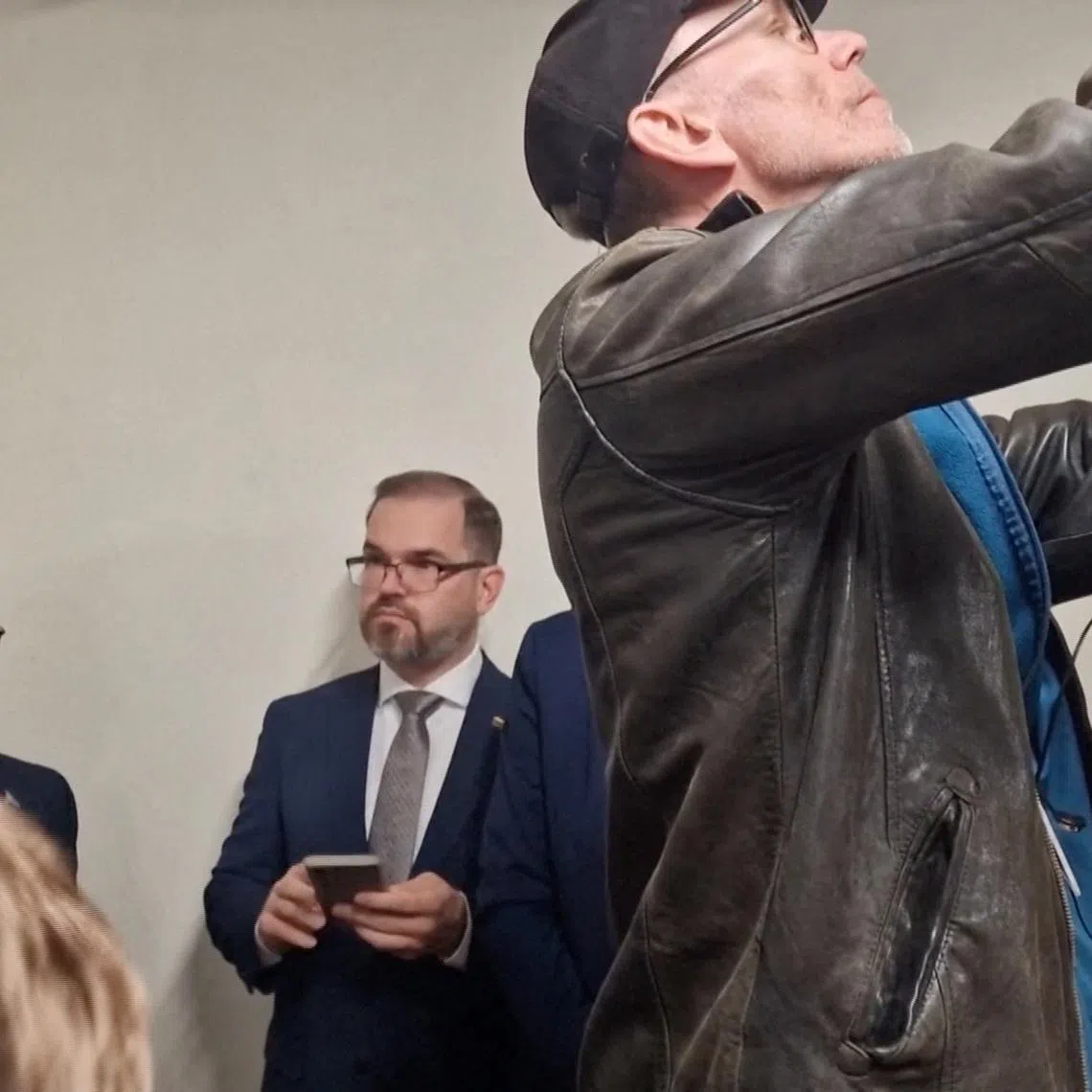 Lithuanian Defence Minister Robertas Kaunas takes shelter at the Lithuanian parliament after an 'air danger' warning, in Vilnius, Lithuania, May 20, 2026, in this screengrab taken from a video. REUTERS/Reuters TV
