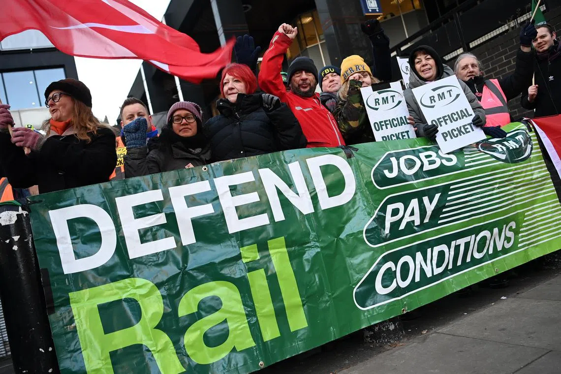 Rail workers picket outside Euston Station in London, Britain, on Dec 14, 2022. 