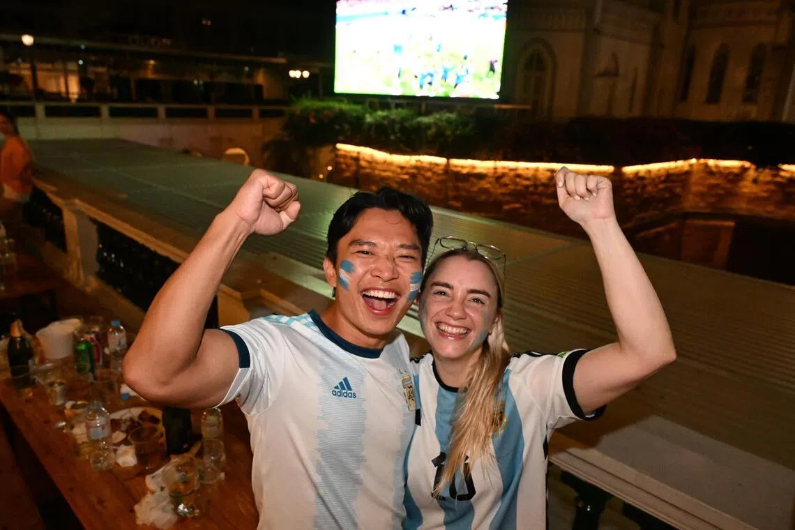 Rio Hoe (left), 33, a Singaporean, and his Argentinian wife Guadalupe Lazaro, 28, at the live screening of the England v Argentina match at CHIJMES on July 16.