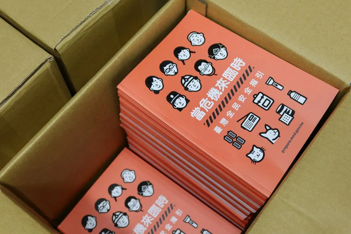 Copies of Taiwan's updated civil defence handbook are stored in a box at a printing house in Taoyuan, Taiwan, September 2, 2025. REUTERS/Fabian Hamacher