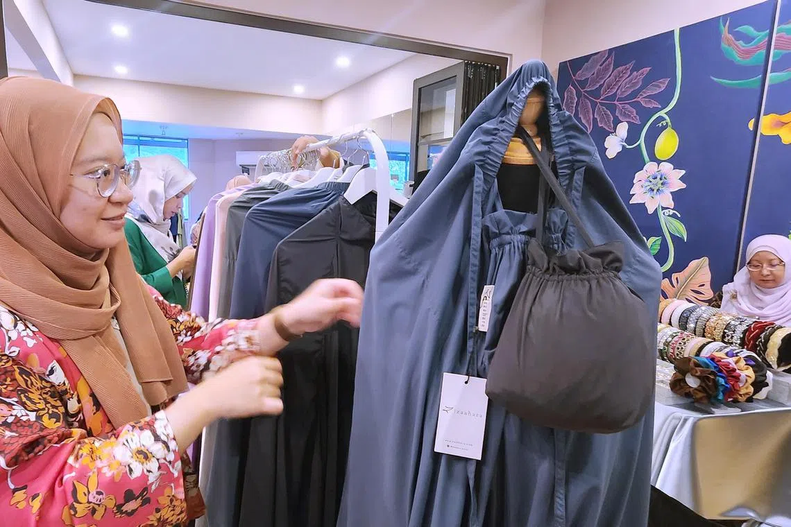 hzhalal - Ms Umamah Ali looking at prayerwear for Muslim women at a stall in Kuala Lumpur, Malaysia. Pic taken Feb 19, 2023.