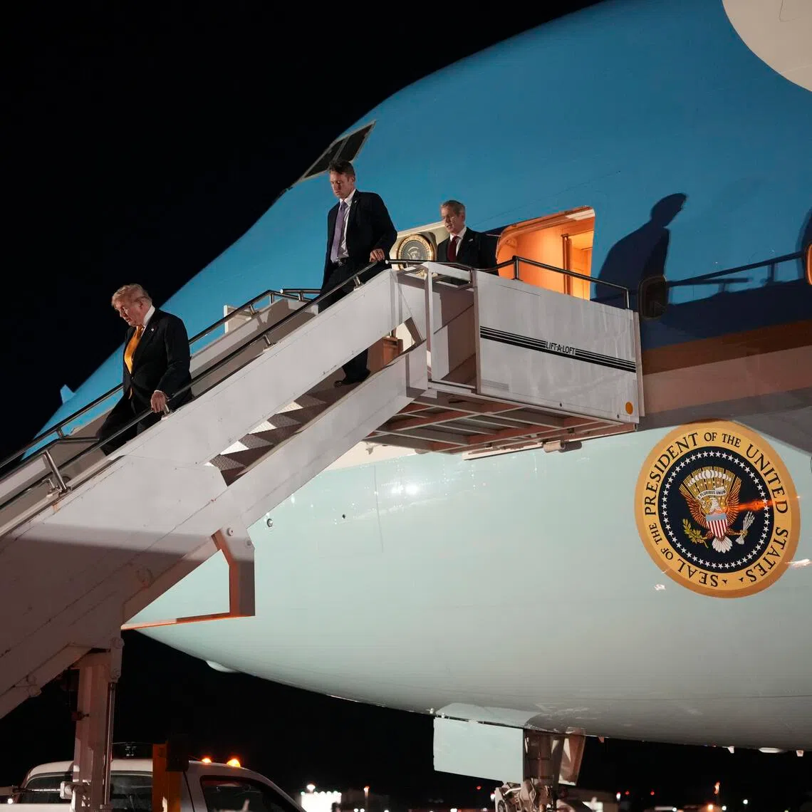 US President Donald Trump disembarks from Air Force One after he had secretly reboarded it at Royal Air Force Mildenhall in Britain on July 8.