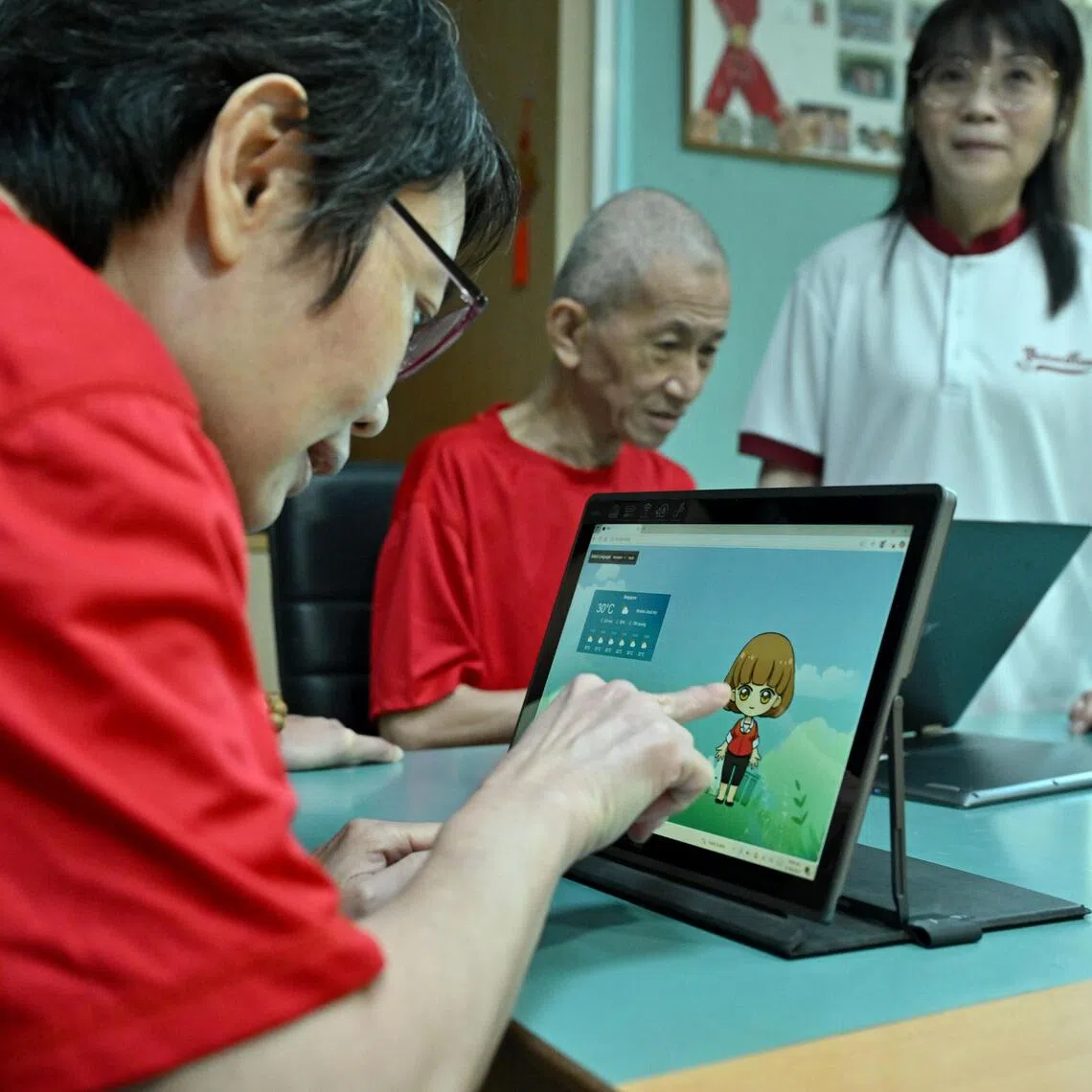 Ms Toh Siew Mui, 49, trying out a prototype of an AI-powered chatbot.