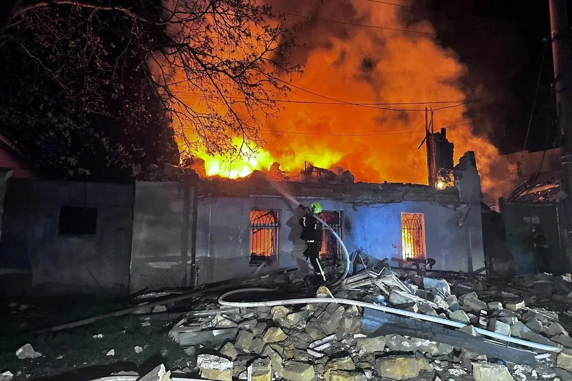 A firefighter working at the site of a residential building hit by Russian drone strikes overnight on April 11., in Odesa, Ukraine.