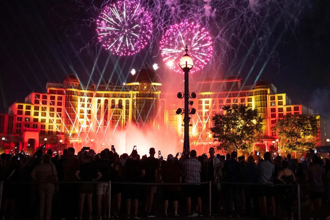People attending a fireworks and light show during the Universal Epic Universe theme park grand opening in Orlando, Florida, US, May 21, 2025. 