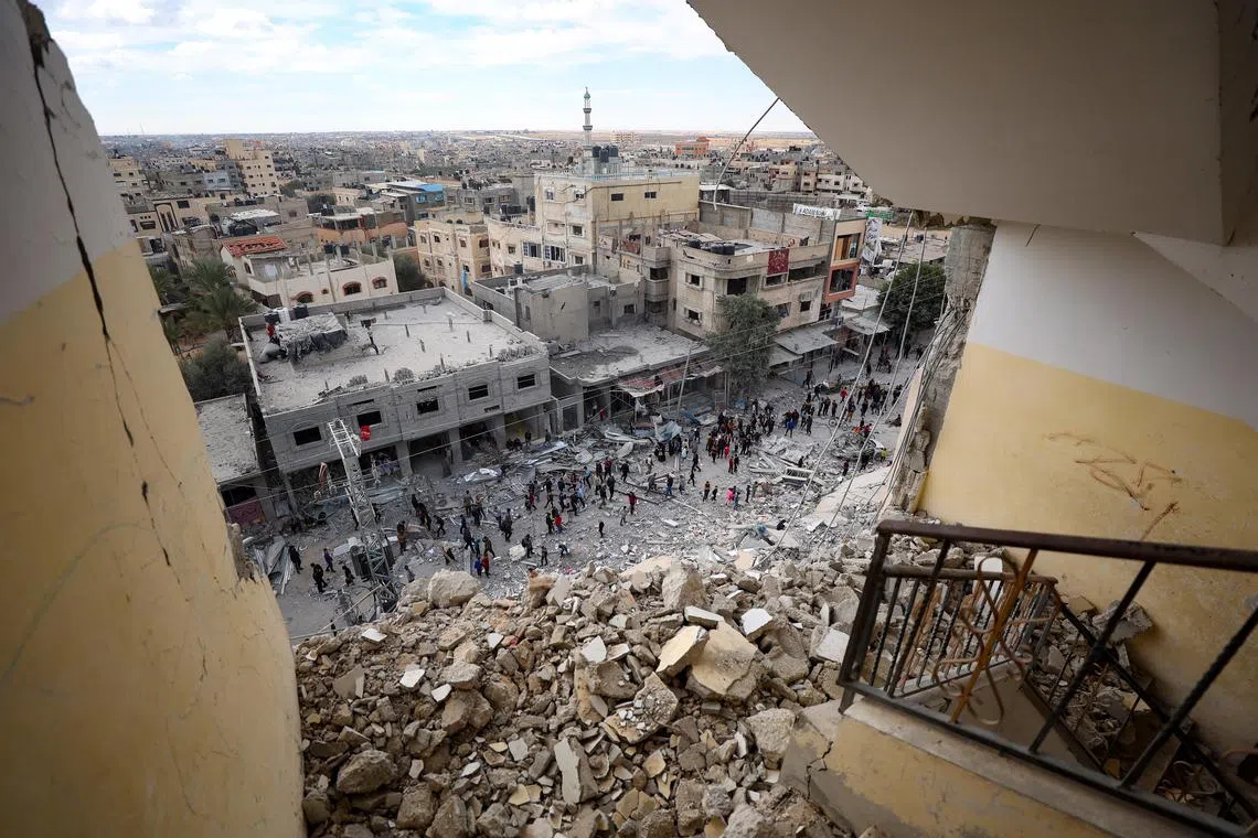 Palestinians inspect the area after an Israeli airstrike hit Al Masry Tower in the Rafah refugee camp in the southern Gaza Strip on March 9.