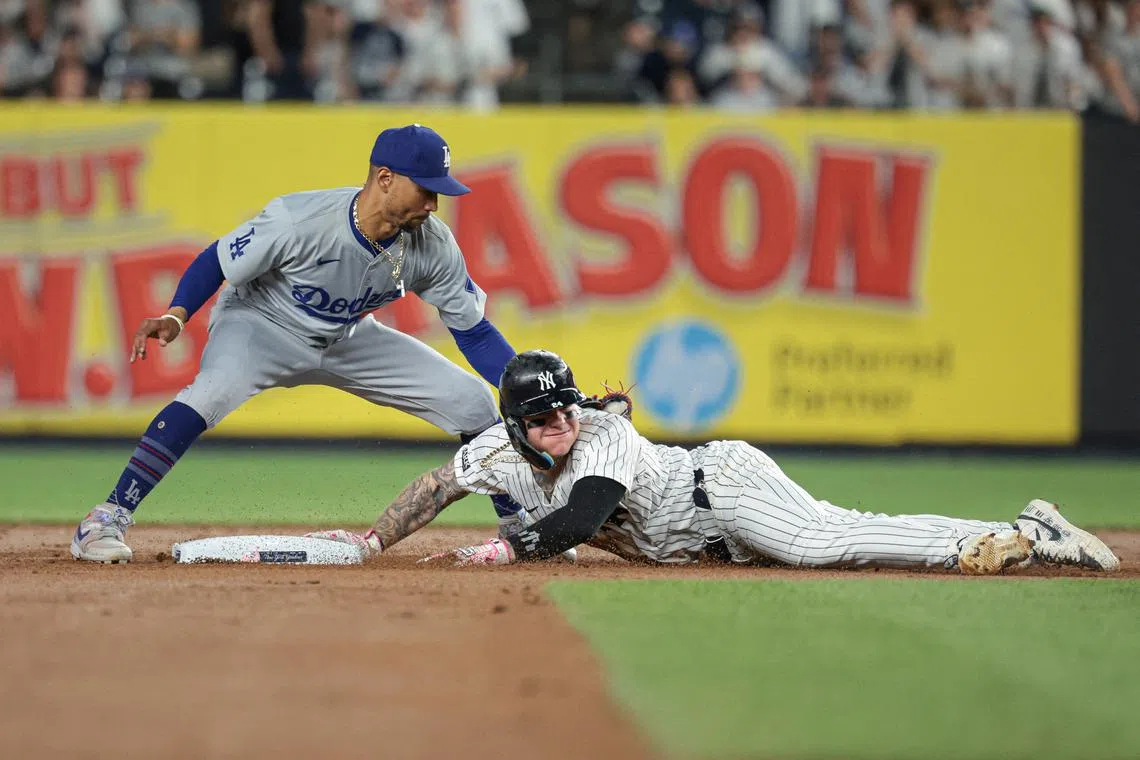 FILE PHOTO: Jun 8, 2024; Bronx, New York, USA; New York Yankees left fielder Alex Verdugo (24) dives safely in to second base beating the tag by Los Angeles Dodgers shortstop Mookie Betts (50) during the fifth inning at Yankee Stadium. Mandatory Credit: Vincent Carchietta-USA TODAY Sports/File Photo