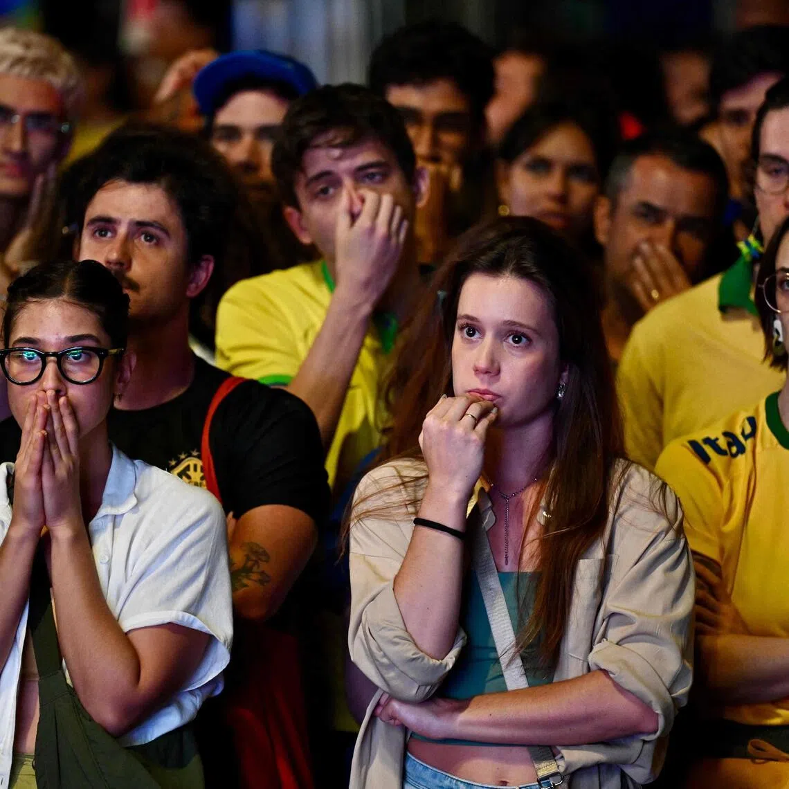 Brazilian fans reacting as they watch the live broadcast of the match between Brazil and Norway on a street in Brasilia, on July 5.