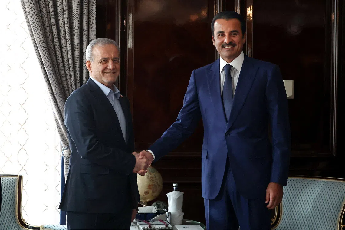 Image 3: Iranian President Masoud Pezeshkian shakes hands with Qatar's Emir Sheikh Tamim bin Hamad Al Thani as they meet in Moscow, Russia, October 27, 2026. Iran's Presidential website/WANA (West Asia News Agency)/Handout via REUTERS